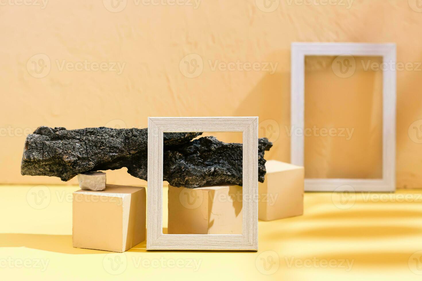 Modern abstract life style background yellow cardboard, plaster, blank photo frames, stones, tree bark and leaf shadow. Place for text