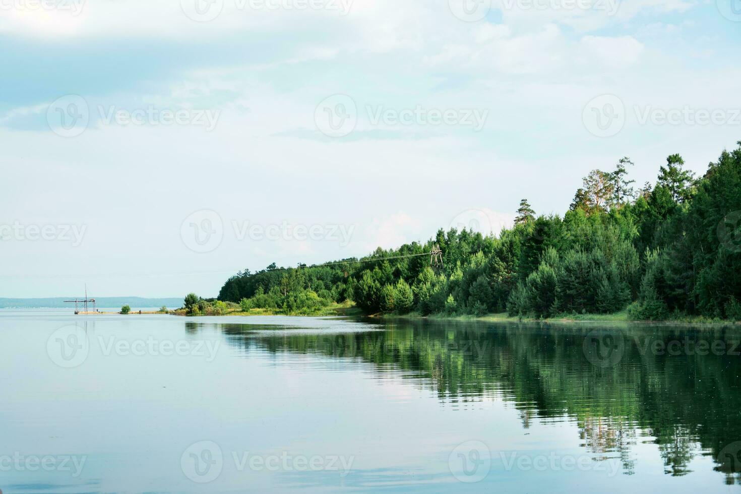 Beautiful landscape - spring flood on the river. The coast with the forest is flooded with water photo