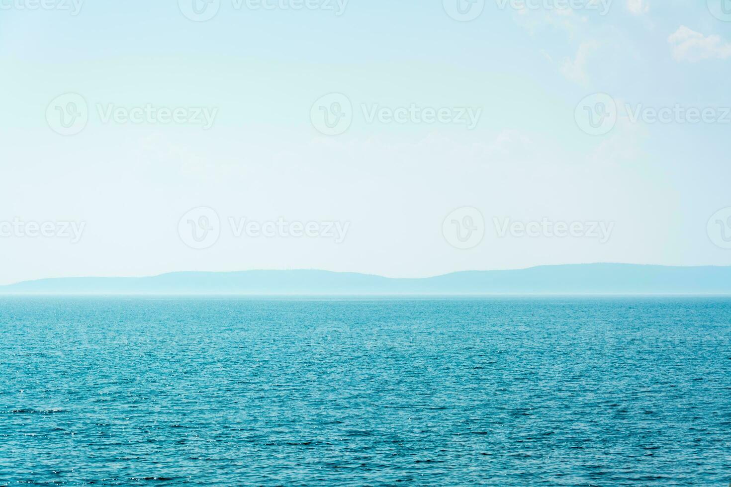 Bay of blue sea and mountains on the horizon. Local tourism photo