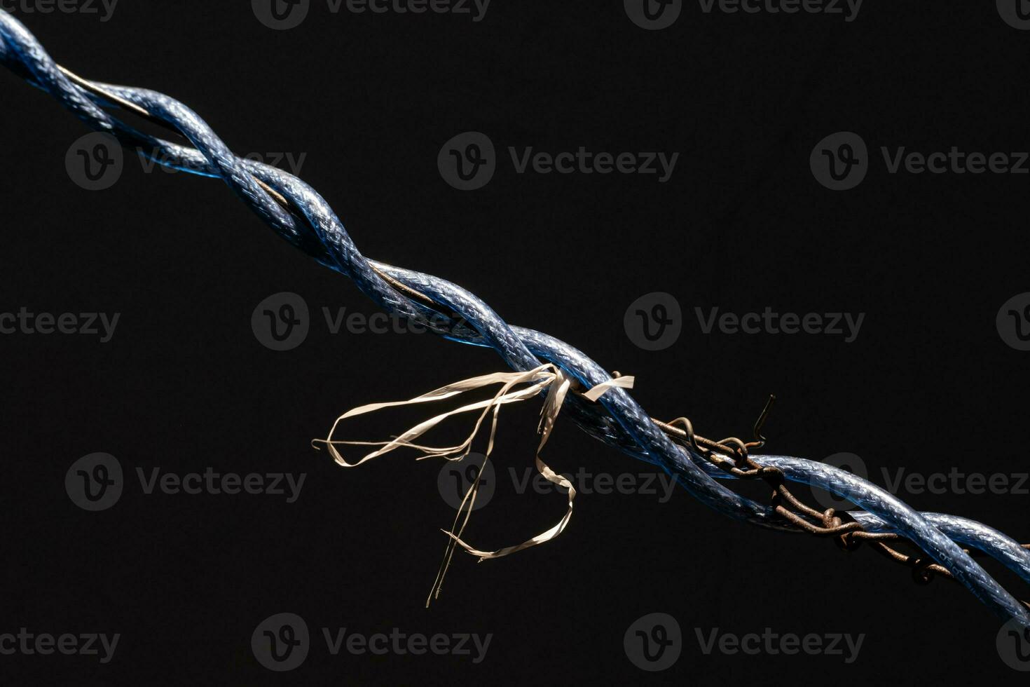 Laos drying clothes with wires tangled around and tied with ropes, creating a strange picture in dark tones. photo