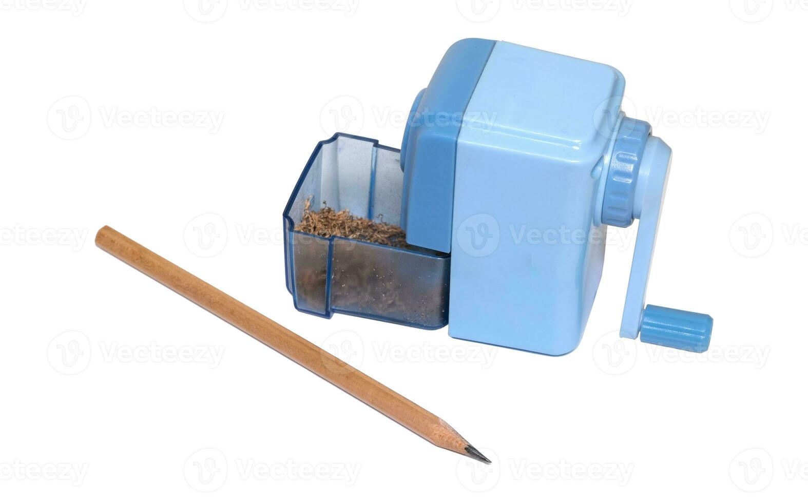 The light blue pencil sharpener is being sharpened. wooden pencils and wooden planks inside Commonly used for school children. photo
