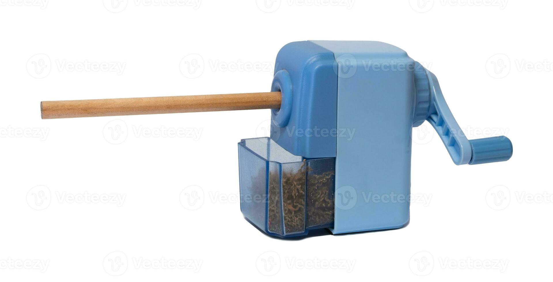 The light blue pencil sharpener is being sharpened. wooden pencils and wooden planks inside Commonly used for school children. photo