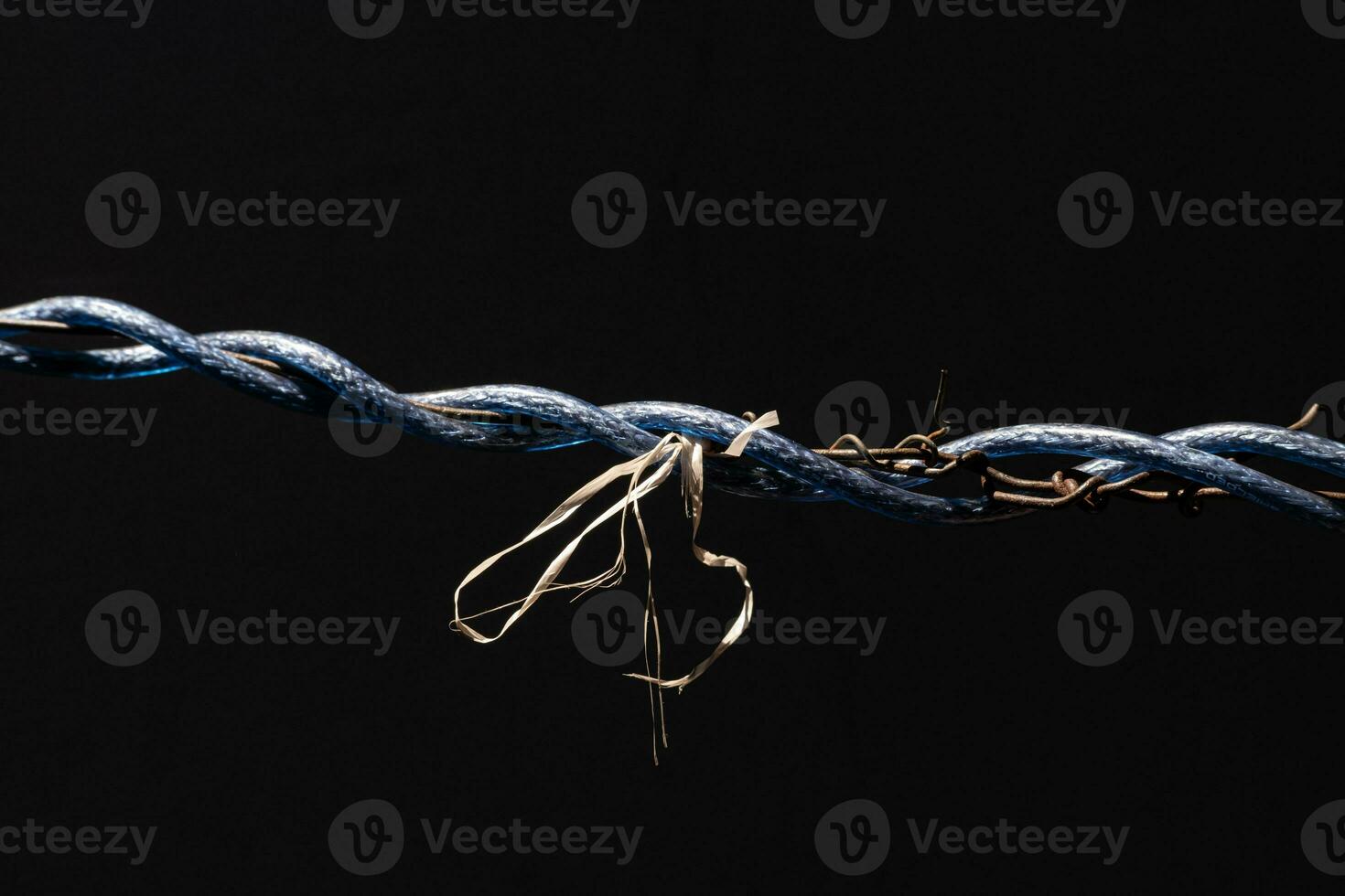 Laos drying clothes with wires tangled around and tied with ropes, creating a strange picture in dark tones. photo