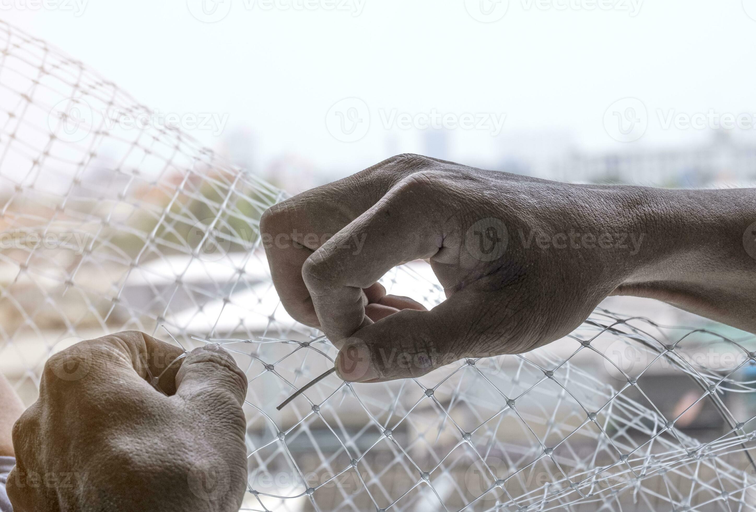 technician worker man install plastic net with cable wire for protect