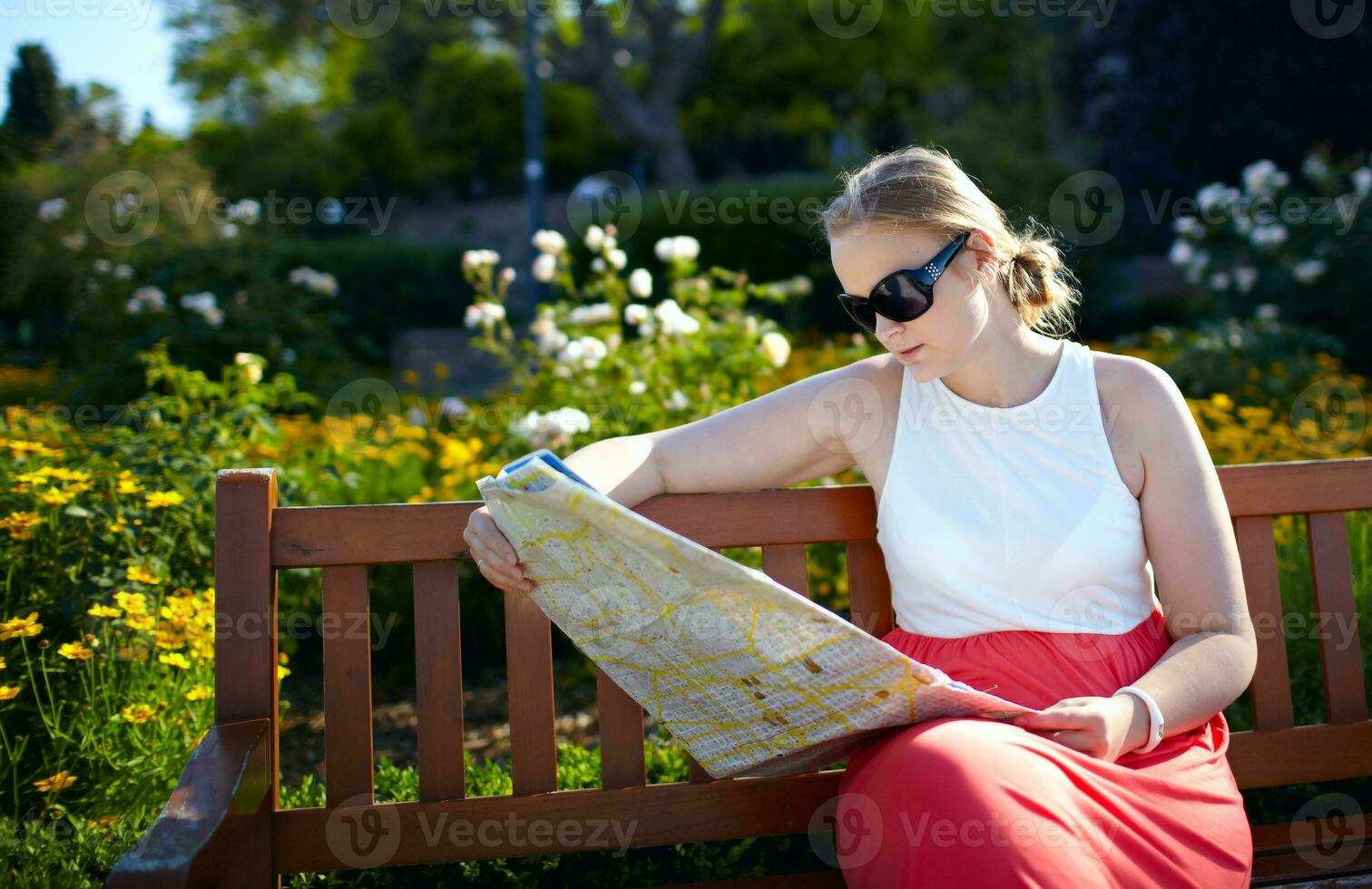 Girl reads the map outdoors photo