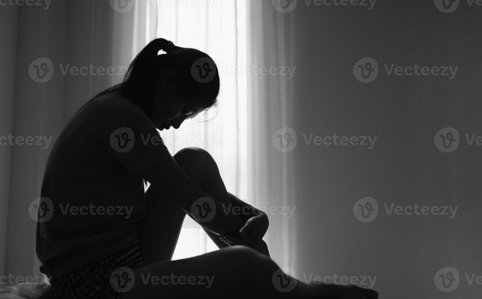 Young depressed woman, domestic and rape violence,beaten and raped sitting in the corner,  Copy space.  International Women's Day photo