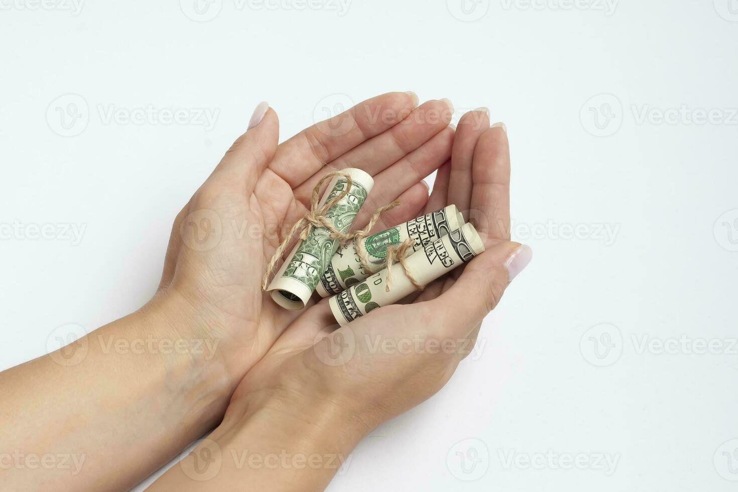 Dollars fan in a female hand isolated on white background. Clipping Path. photo