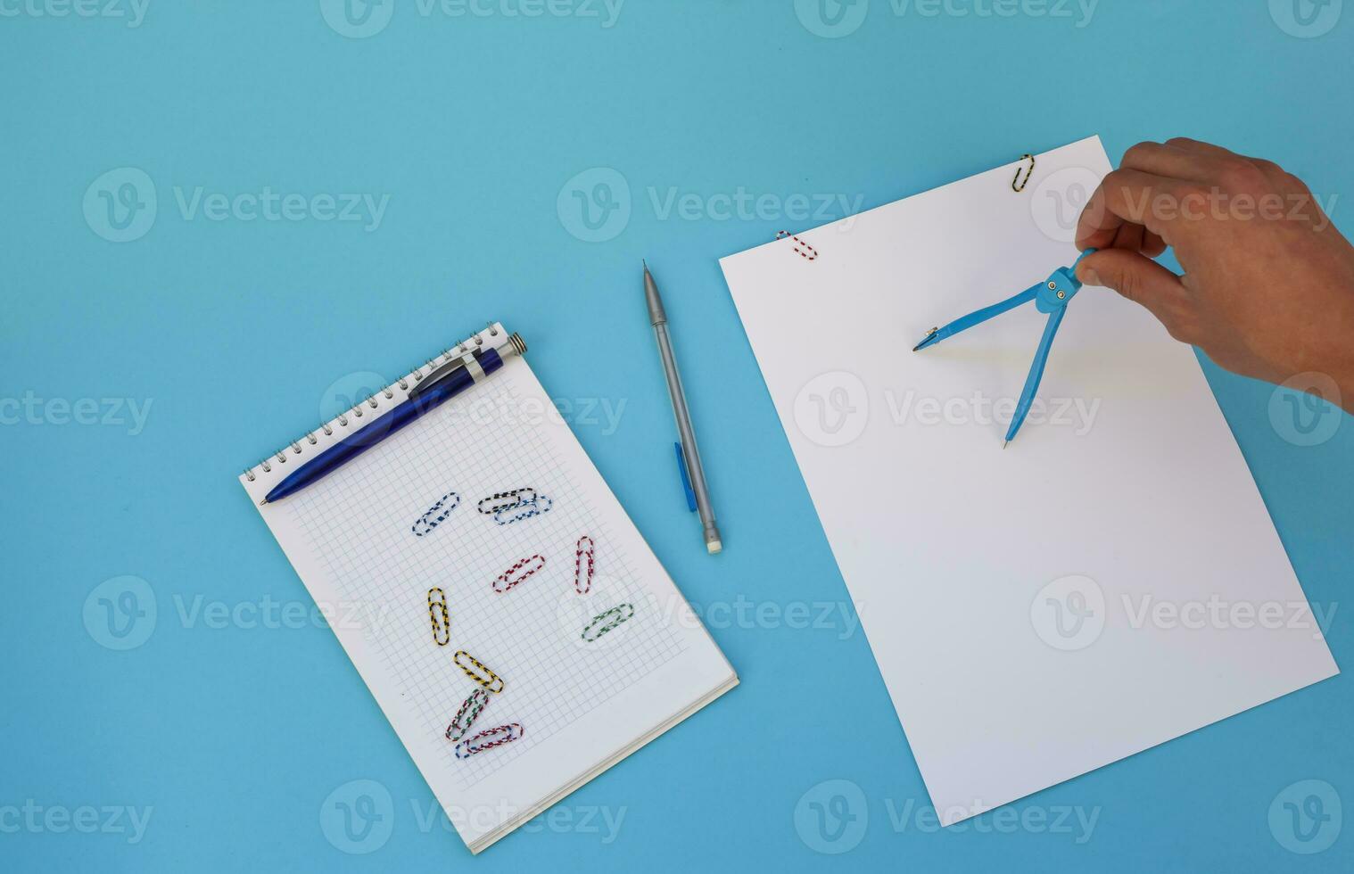 Engineer's hands working with compasses. Top view. Free space for text. photo