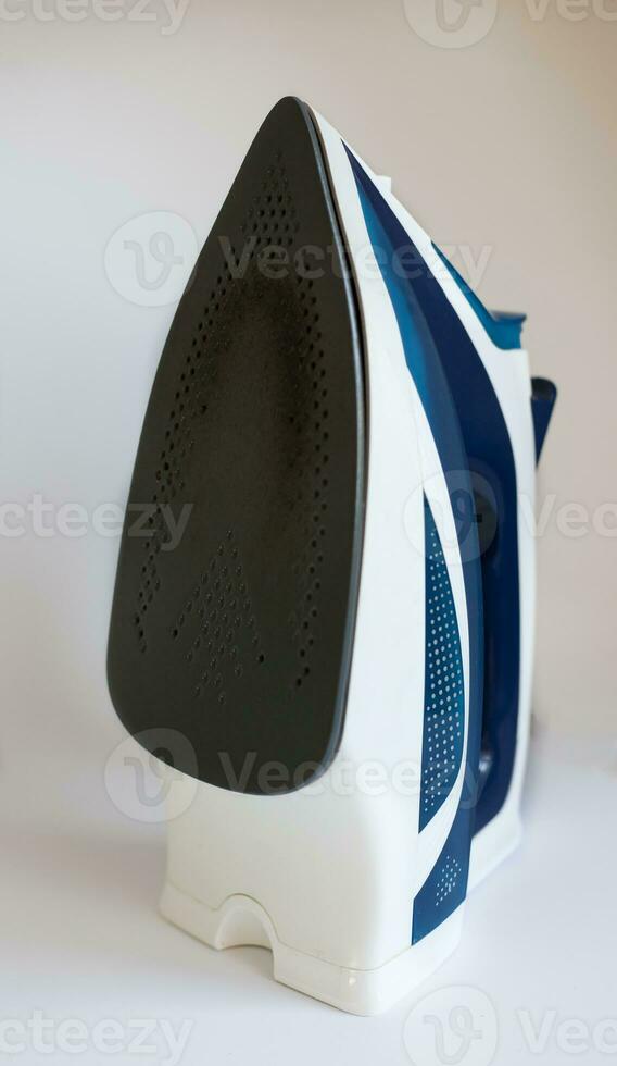 used dirty iron not suitable for ironing. home appliance service concept. photo