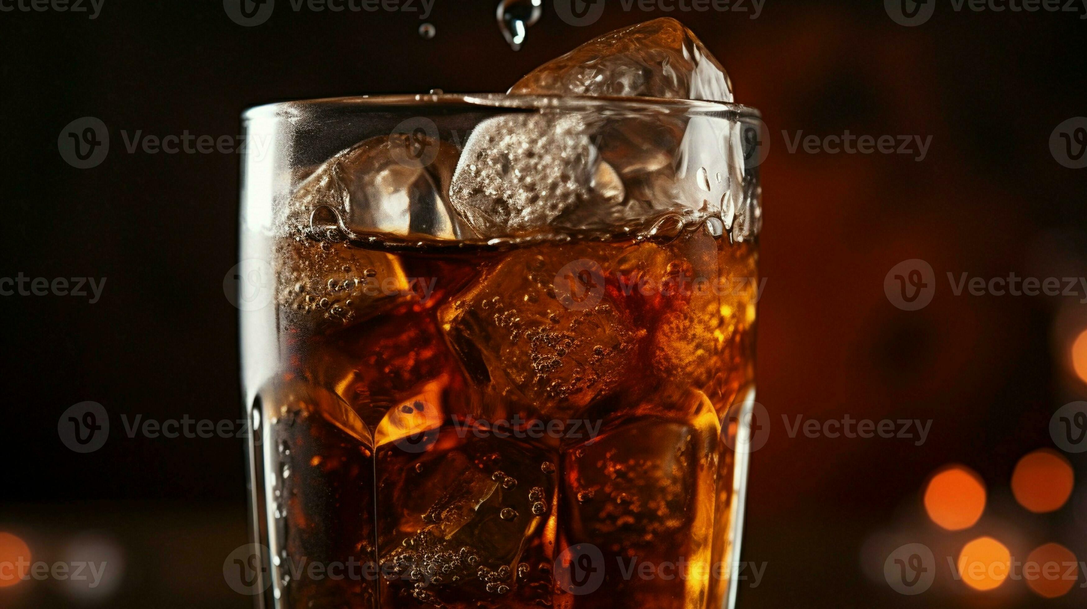 Inside a glass of CocaCola, ice cubes bubble as the refreshing drink