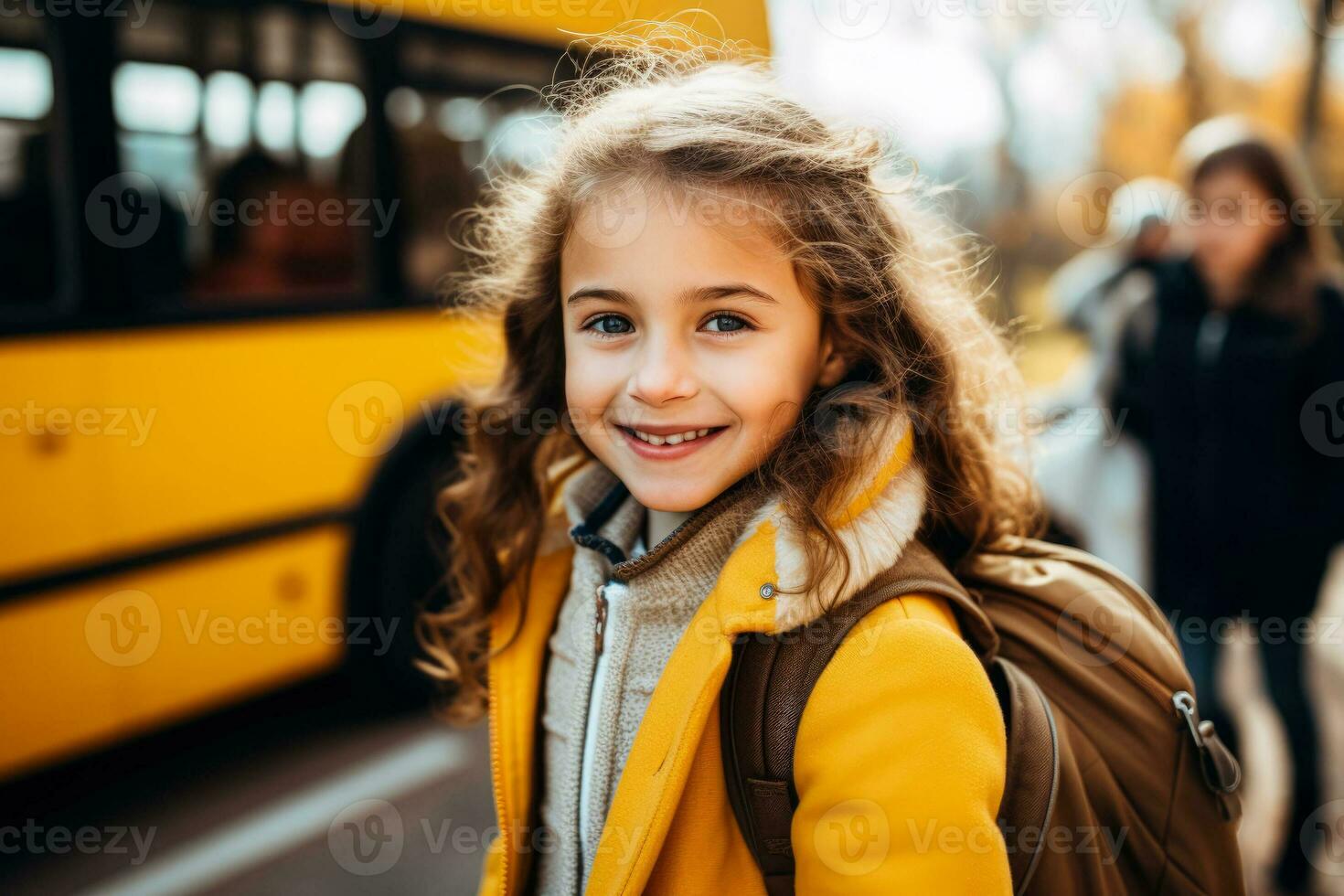 Elementary student girl smiling and ready to board school bus photo