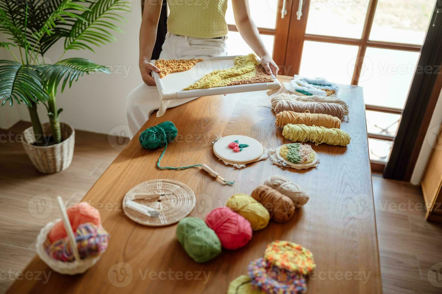 Punch needle. Asian Woman making handmade Hobby knitting in studio workshop. designer workplace Handmade craft project DIY embroidery concept. photo