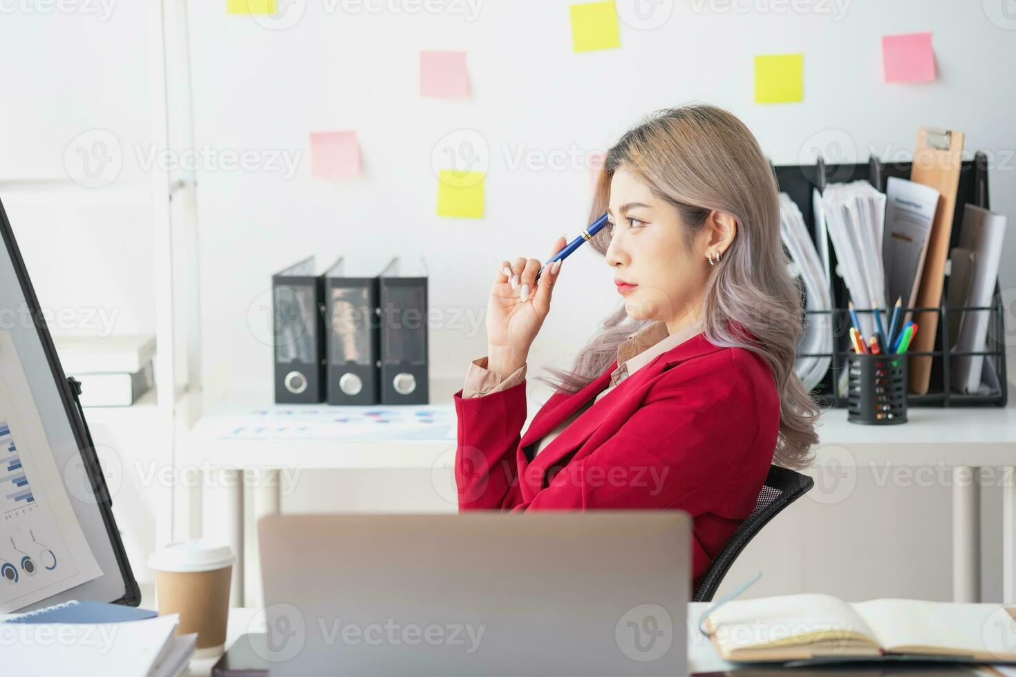 Asian businesswoman presenting a profitable company marketing plan with confidence at the office and future investment plans of the company with charts and graphs on the board. photo