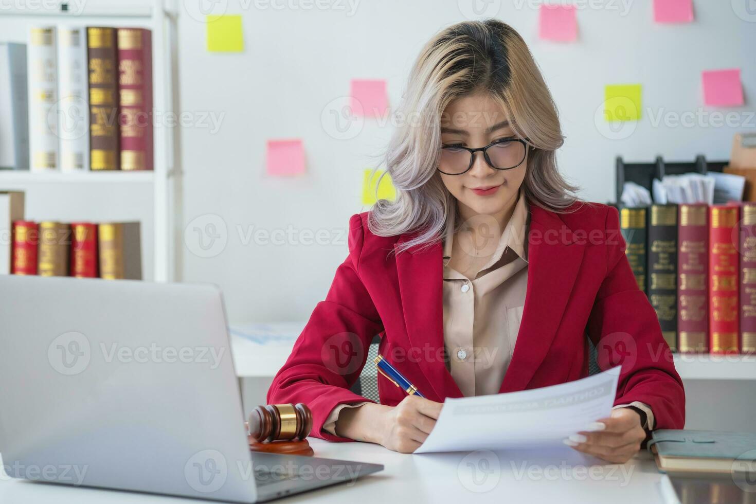 Asian female lawyer or legal advisor signing a contract The contract documents that work on your desk in the law office are there to guide you. photo