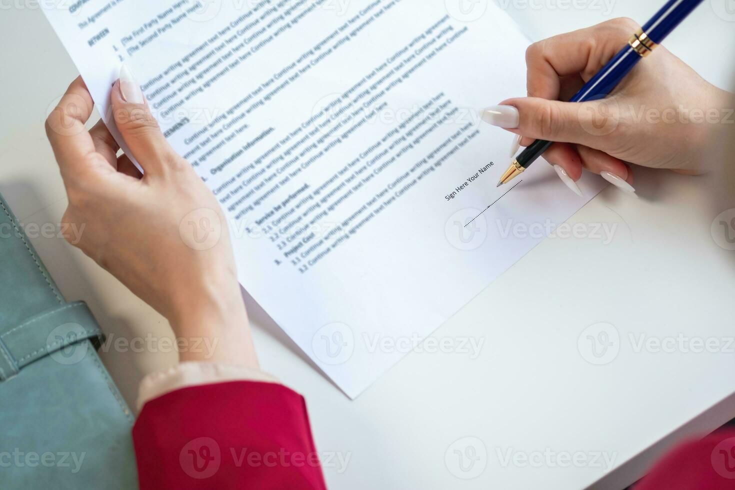 Asian female lawyer or legal advisor signing a contract The contract documents that work on your desk in the law office are there to guide you. photo
