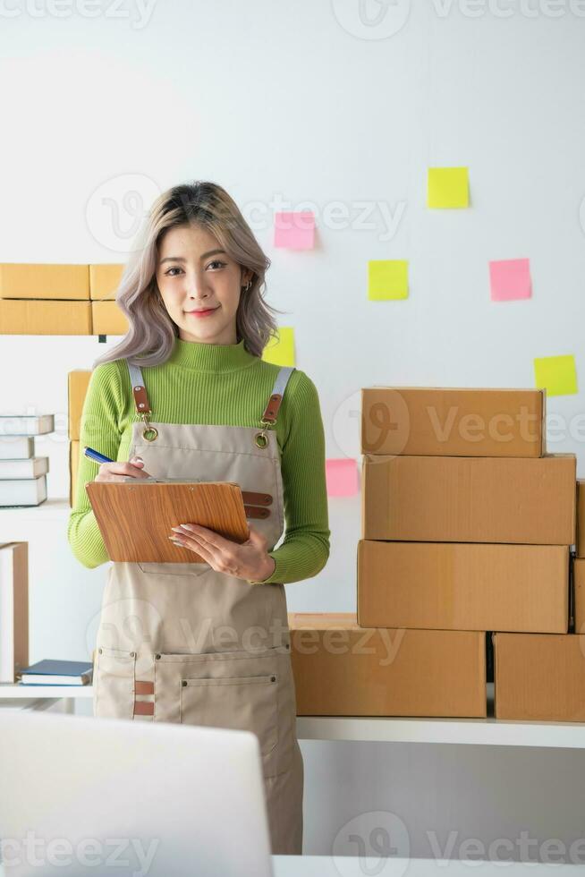 Starting a small business SME business owners, entrepreneurs, unboxing work check order online To prepare to pack into boxes for sale to customers, SME business ideas online. photo