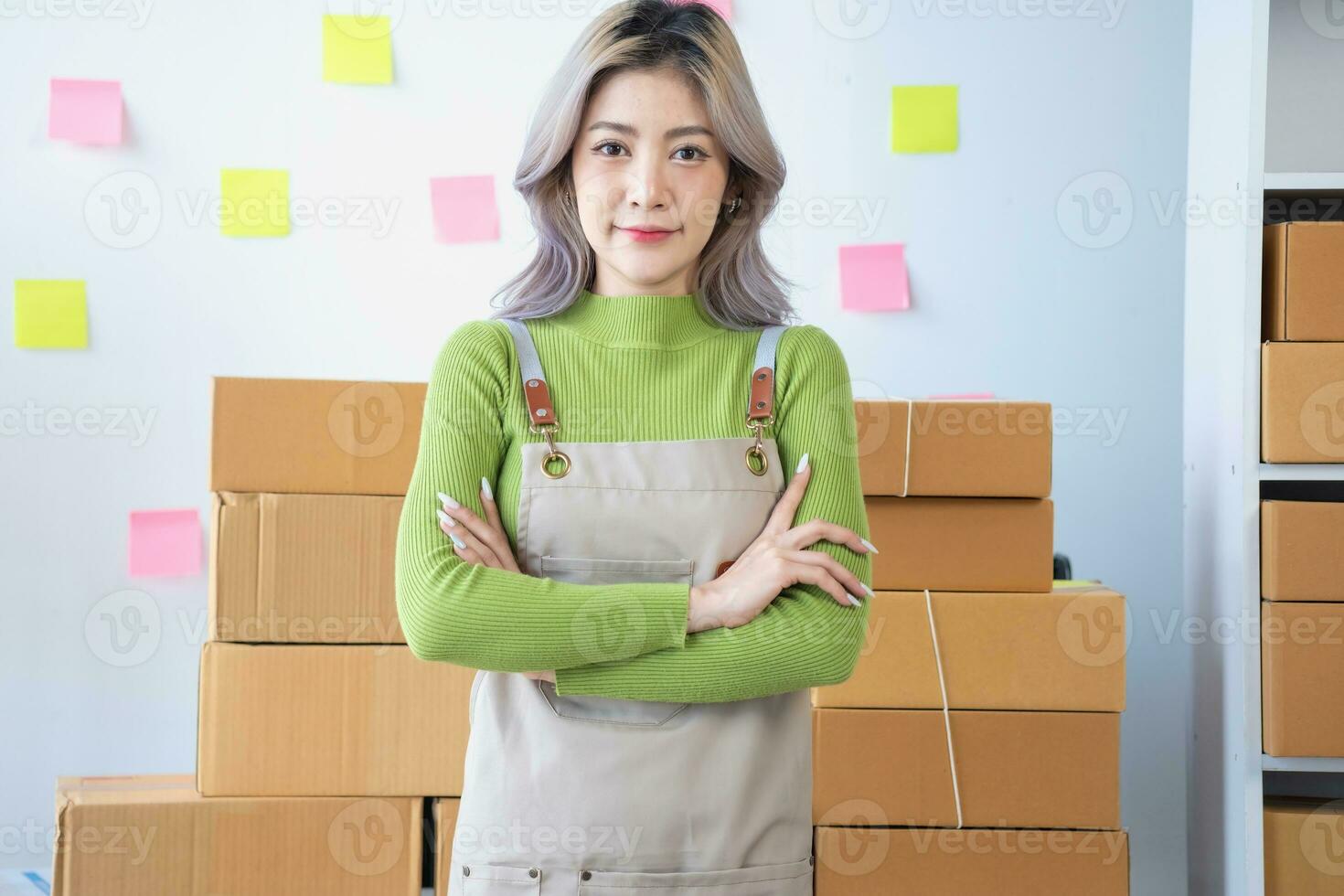 Small business entrepreneur SME, smile asian young woman, girl owner standing confident with arms crossed prepare order send to customer packing box to delivery, working online at home, ecommerce. photo