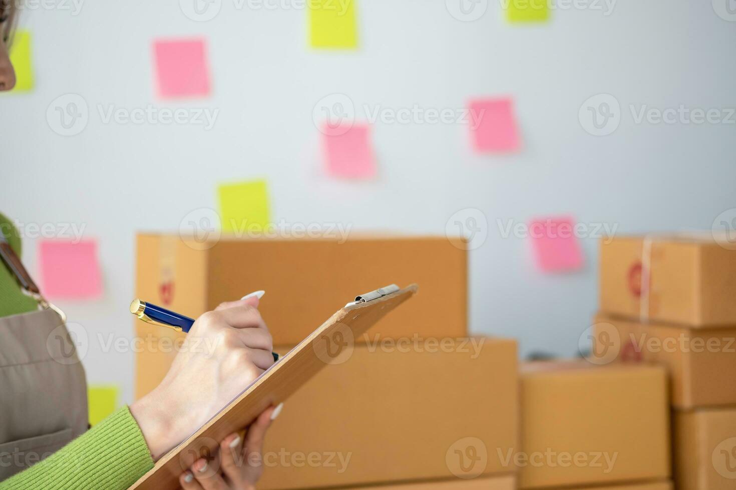Starting a small business SME business owners, entrepreneurs, unboxing work check order online To prepare to pack into boxes for sale to customers, SME business ideas online. photo