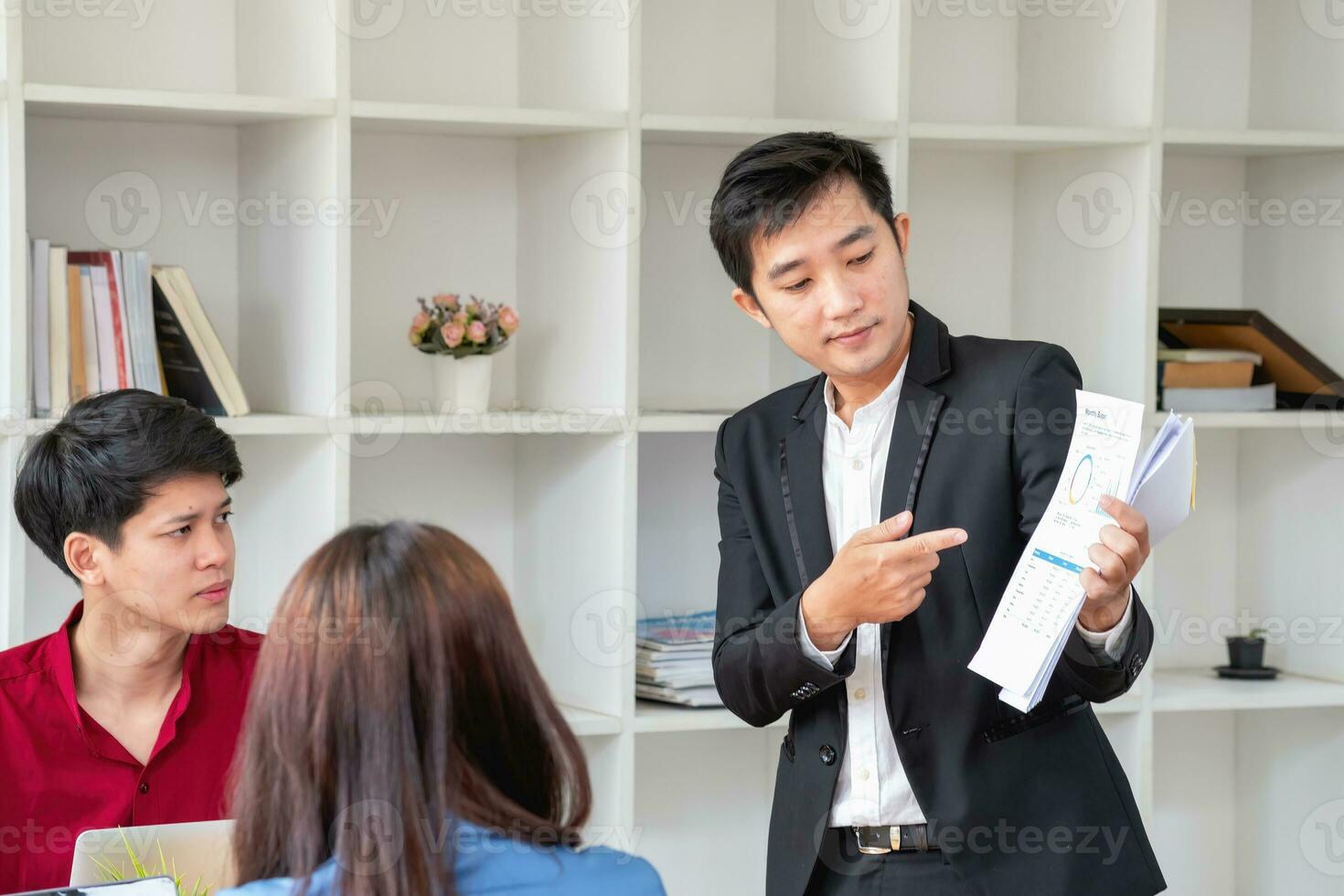 Asian business team consists of marketing staff. accountant and financial officer Help each other analyze company profits using tablets. calculator Laptop computers, graph paper, and corporate pens. photo