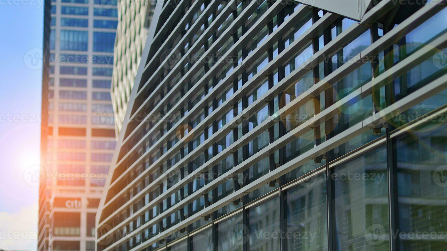 Modern office building in the city with windows and  steel and aluminum panels wall. Contemporary commercial architecture, vertical converging geometric lines. photo