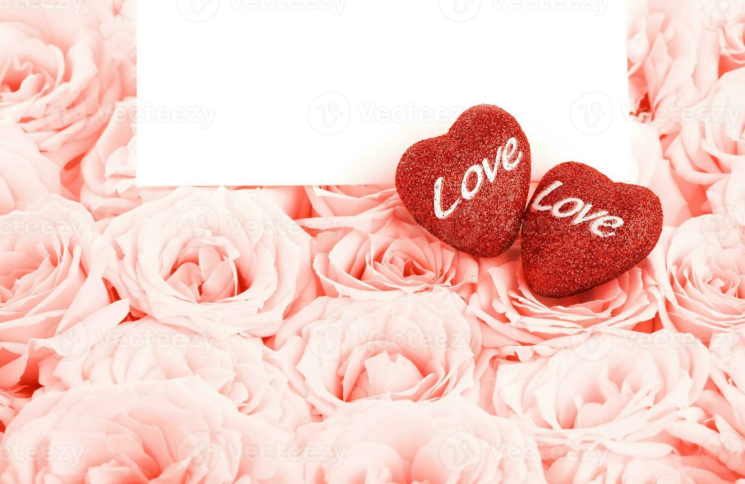 Beautiful pink roses with gift card and hearts photo