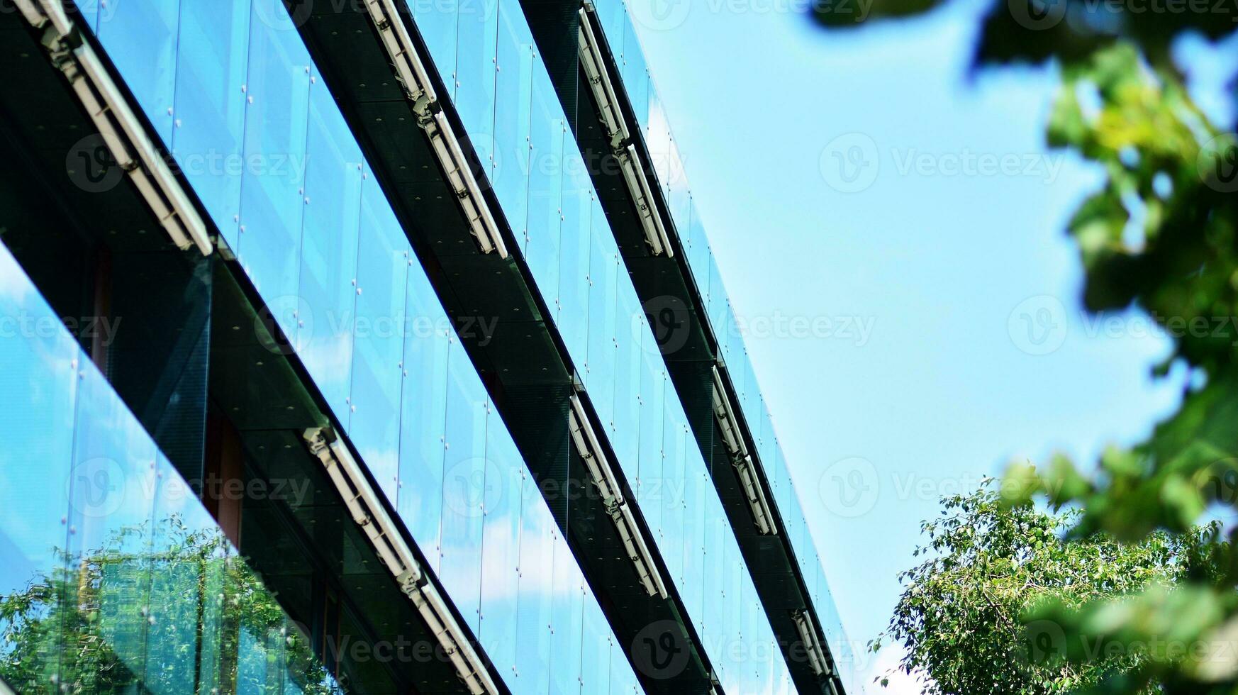 Modern residential building with new apartments in a green residential area. Eco architecture. Green tree and new apartment building. The harmony of nature and modernity. photo