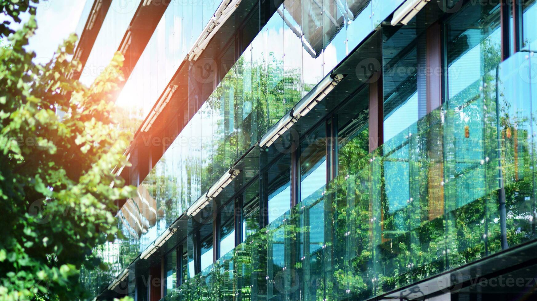Modern residential building with new apartments in a green residential area. Eco architecture. Green tree and new apartment building. The harmony of nature and modernity. photo