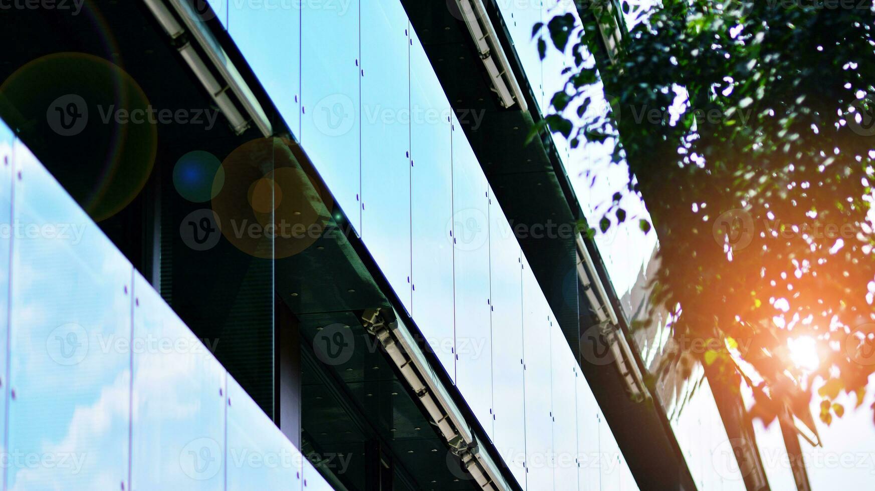 Modern residential building with new apartments in a green residential area. Eco architecture. Green tree and new apartment building. The harmony of nature and modernity. photo