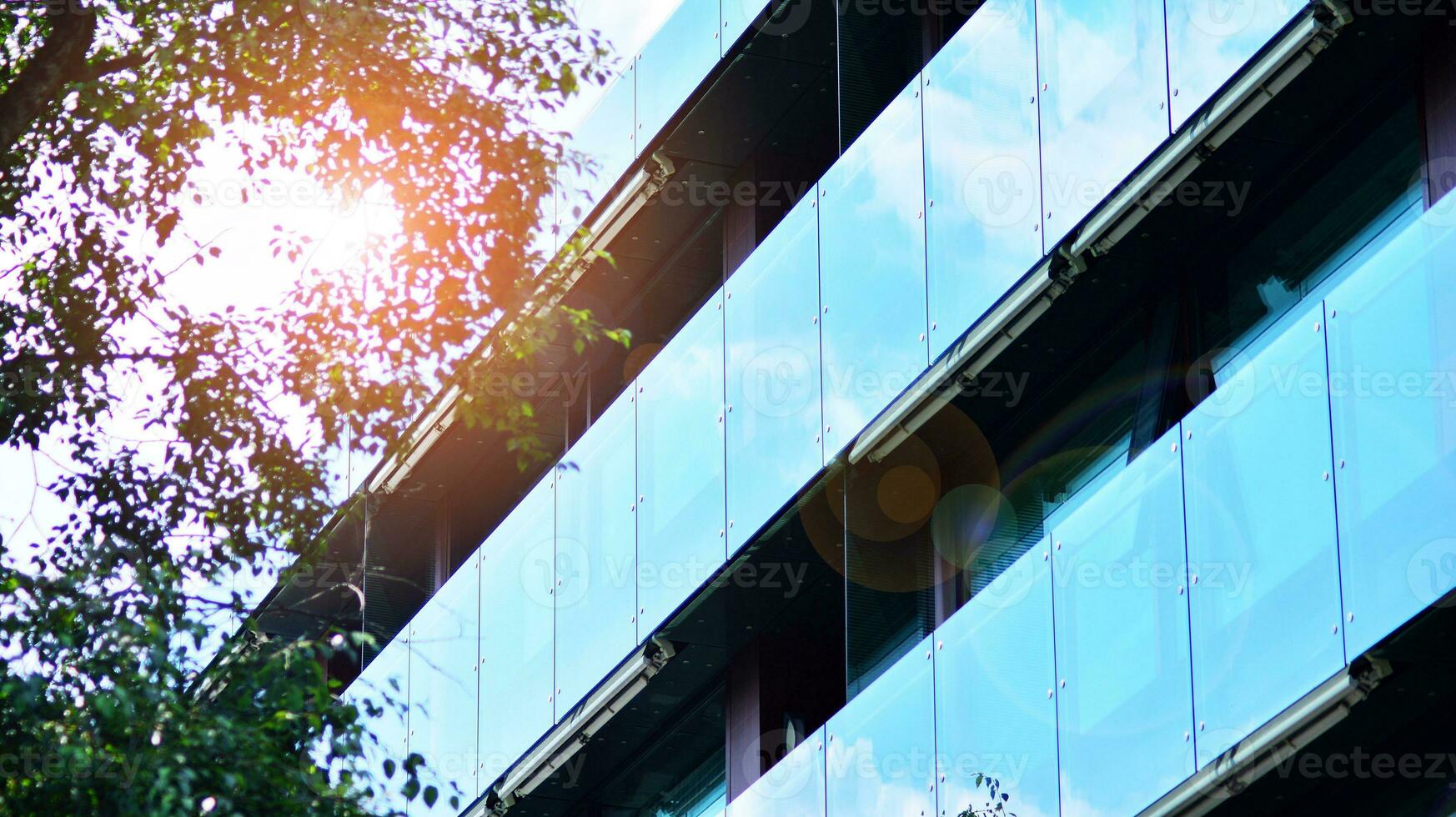 Modern residential building with new apartments in a green residential area. Eco architecture. Green tree and new apartment building. The harmony of nature and modernity. photo