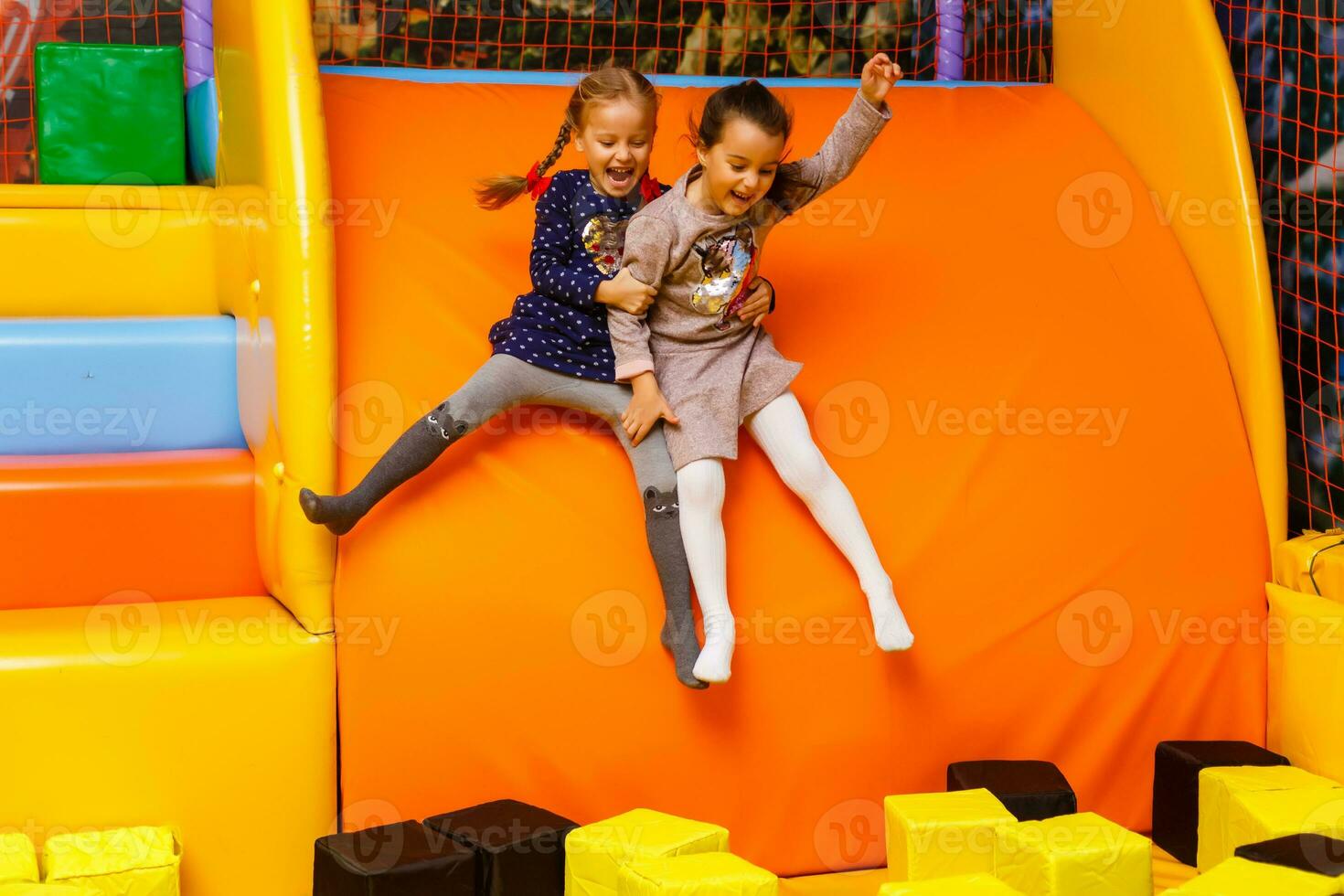 Two sisters bouncing in the trampoline park photo