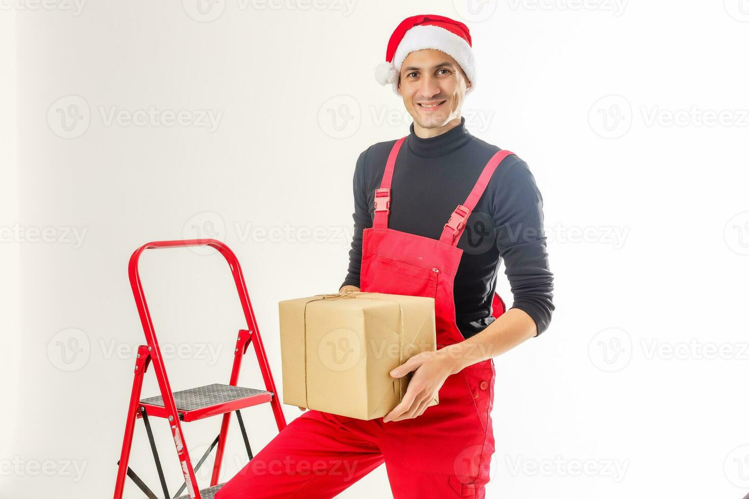 friendly worker with cardboard box stepping forward. isolated on white photo