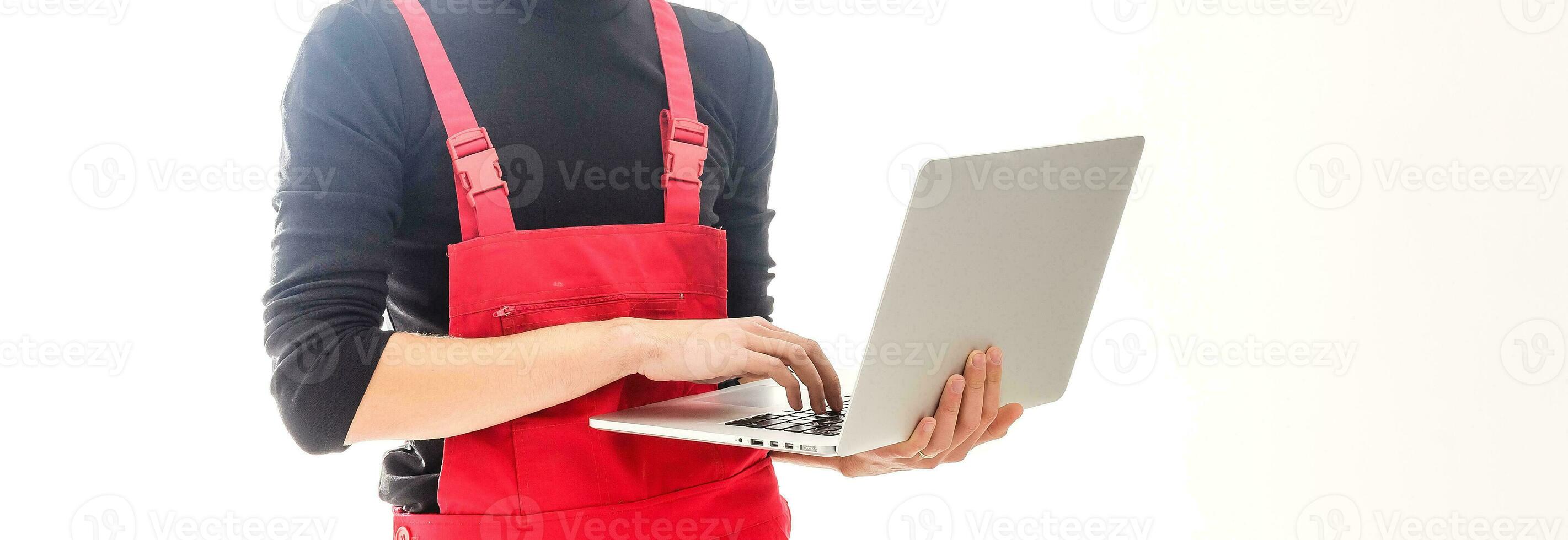 Mechanic with laptop over white background photo