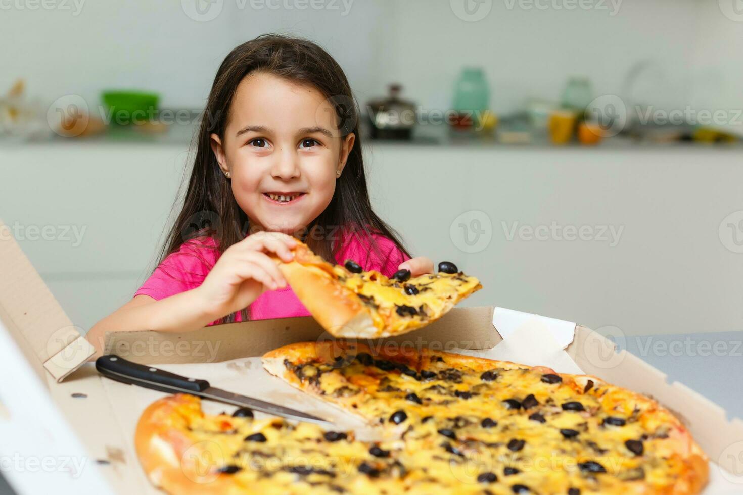 Pretty girls smiling when drinking juice and eating pizza photo