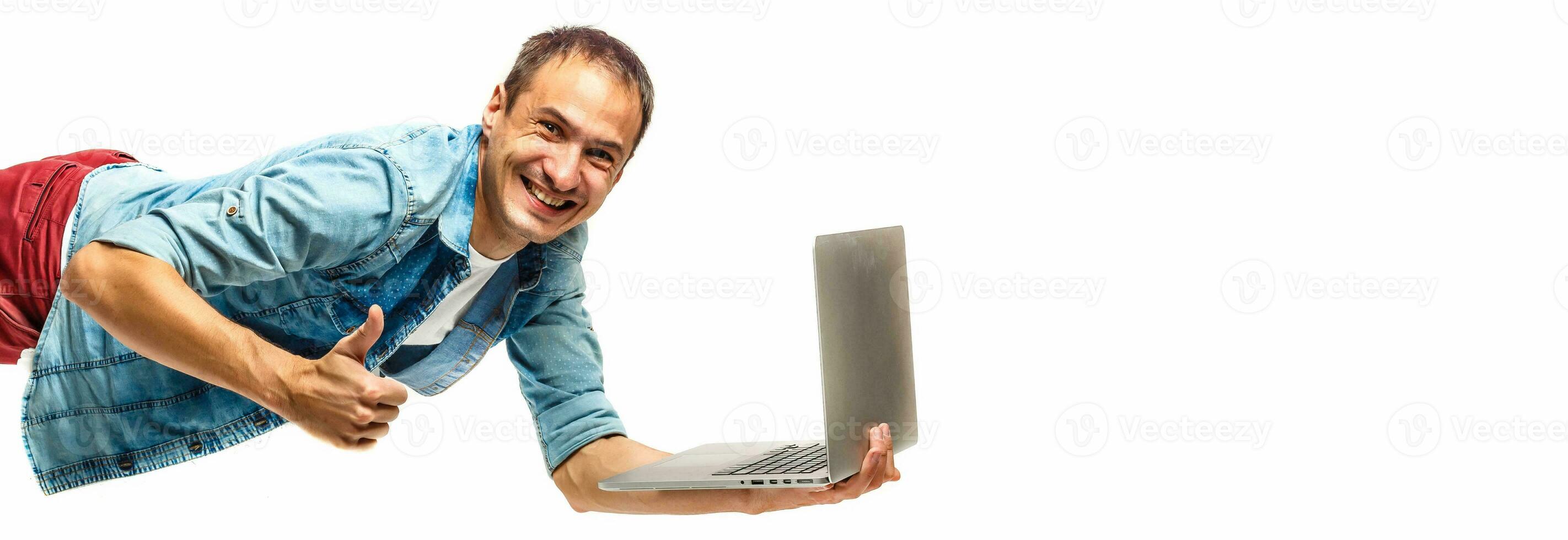 Young hipster man with laptop in the air. isolated on white. Concept communication. photo