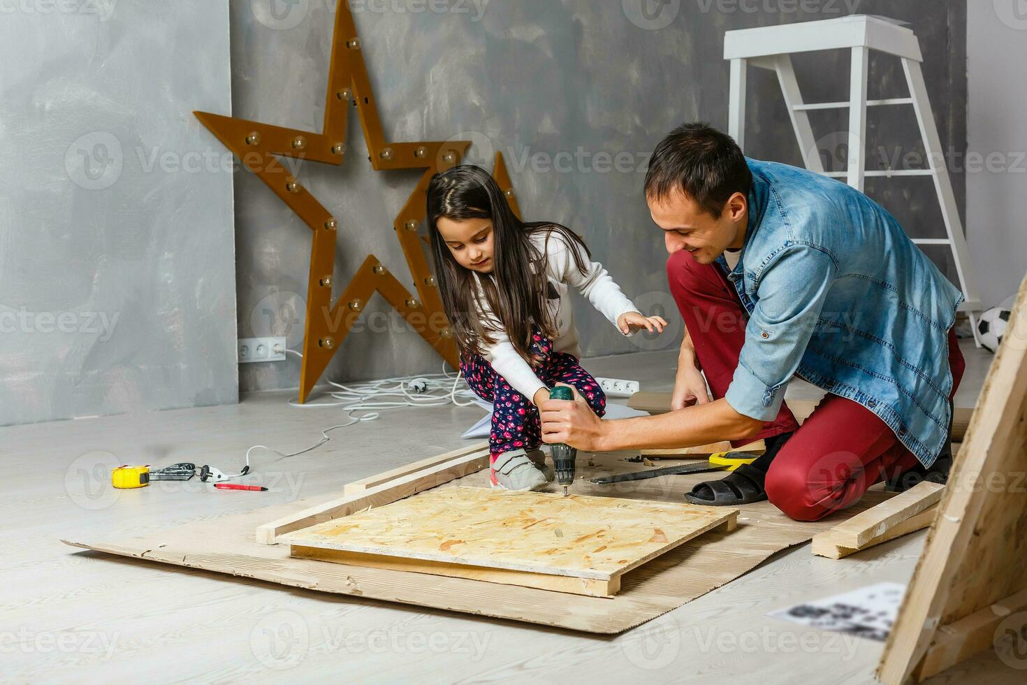 father and daughter are repairing in the garage photo