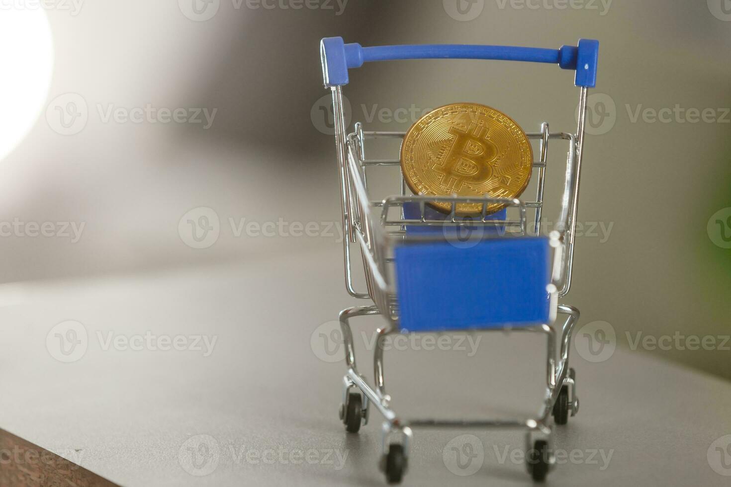 Shop trolley for purchases with bitcoins. Crypto currency bitcoin on a black background. Empty space for text. photo