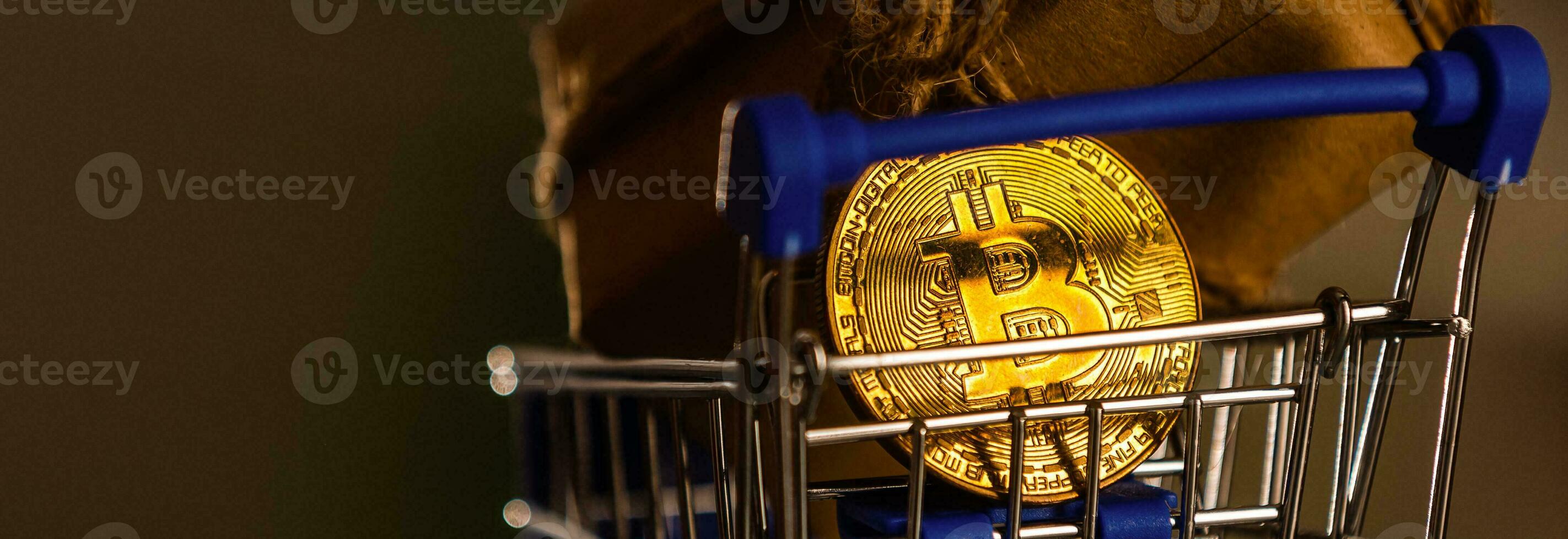 Finance and investment concept - bitcoin with shopping cart and gifts photo