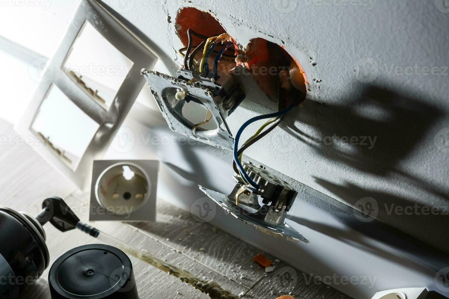 Two sockets during installation without cover. During the repair. open wires. European socket without cover isolated on white background. Professional installation of electric sockets photo