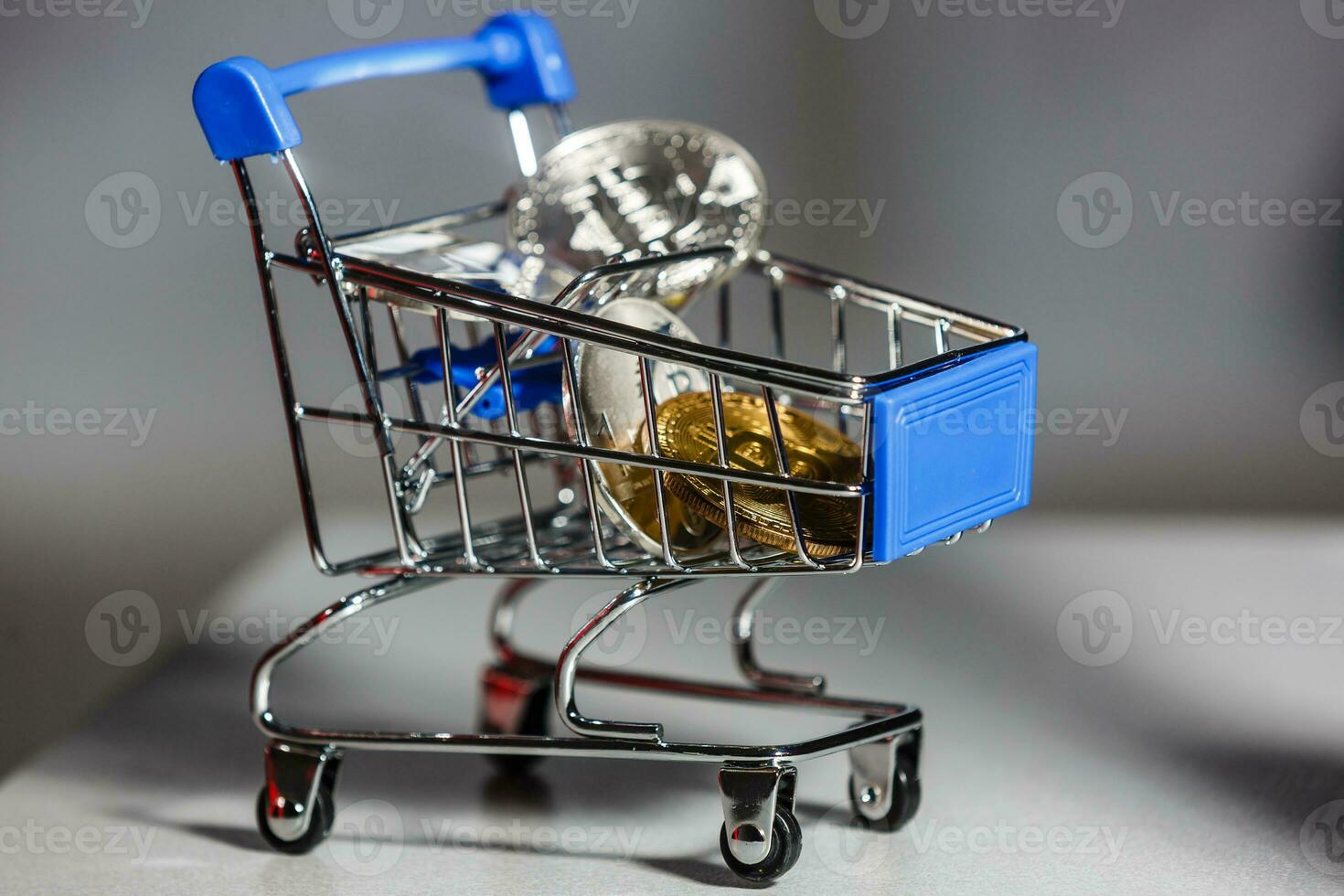 Shop trolley for purchases with bitcoins. Crypto currency bitcoin on a black background. Empty space for text. photo