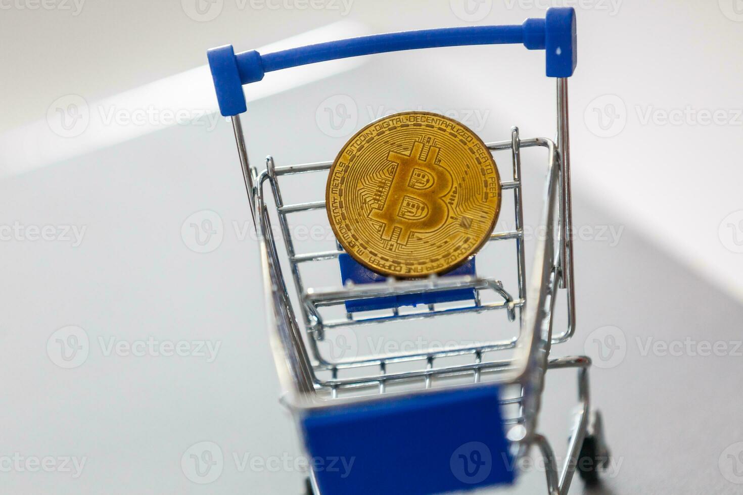Shop trolley for purchases with bitcoins. Crypto currency bitcoin on a black background. Empty space for text. photo
