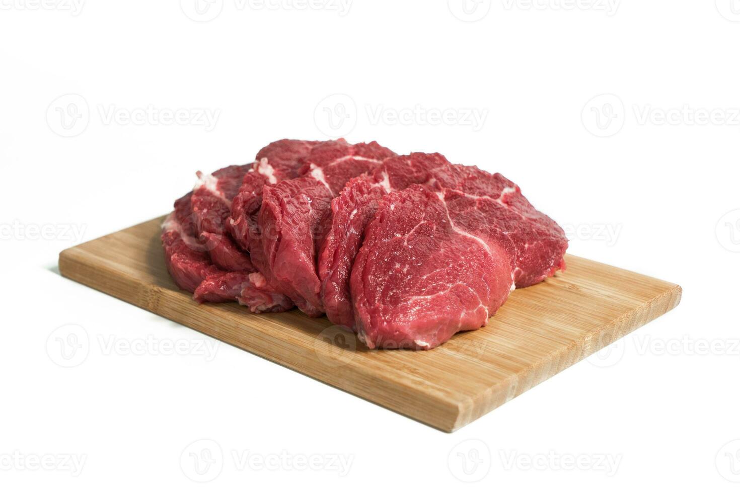 Freshness raw beef in pieces on the cutting board with white background. photo