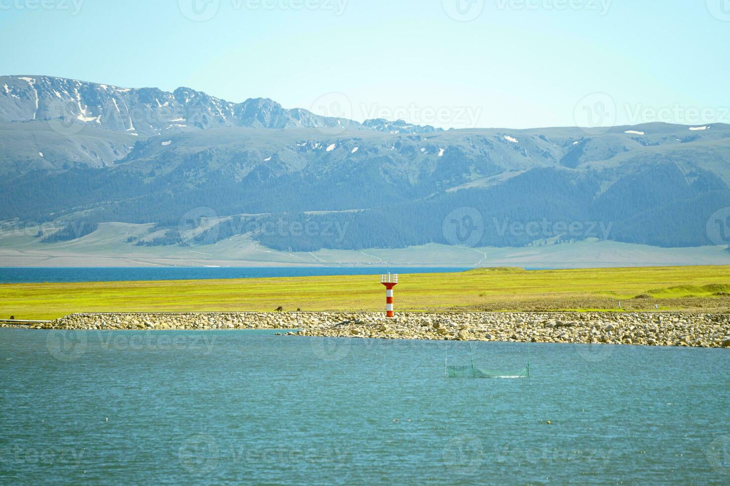 Road and lighthouses on the lake. Shot in Sayram Lake in Xinjiang, China. photo