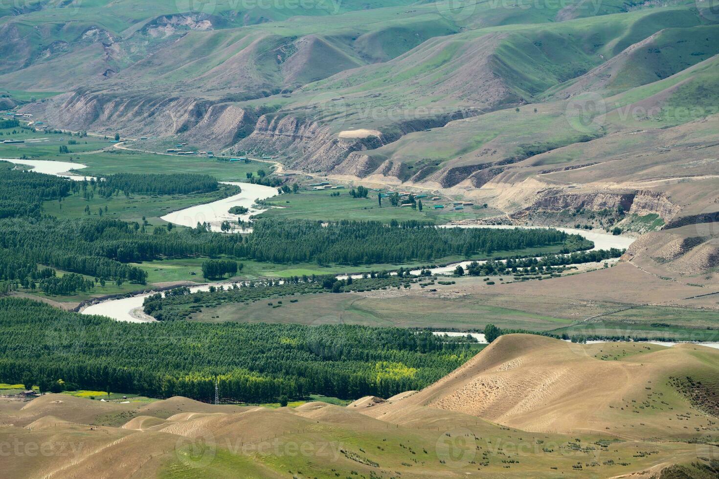 Meandering river and mountains in a sunny day. photo