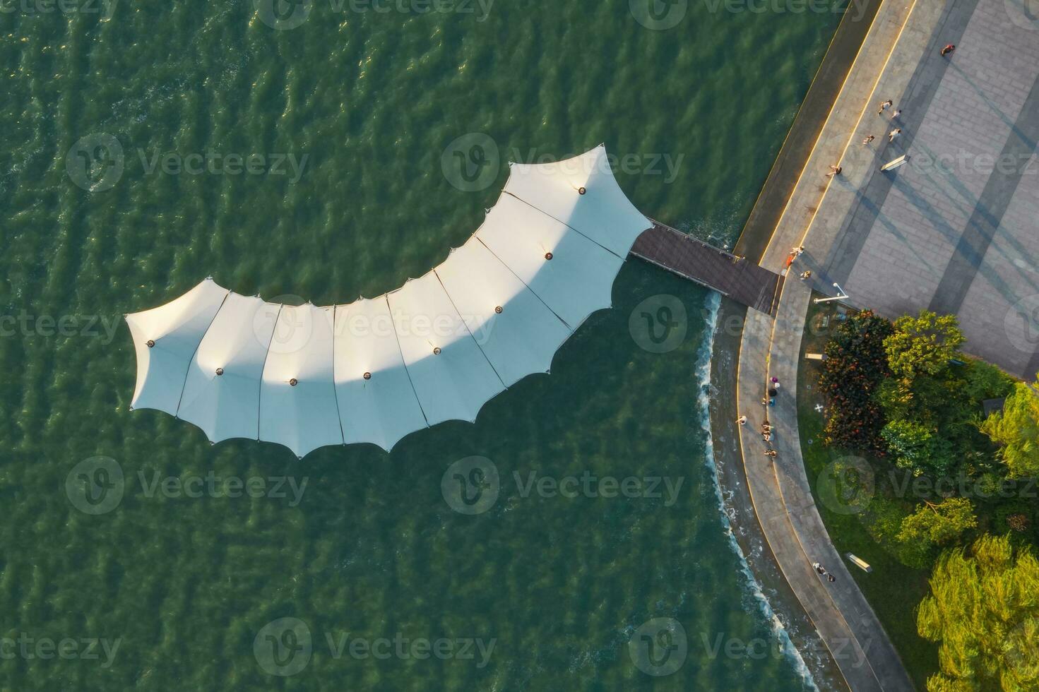 Sailboat pavilion and wooden pathway by the lake. photo