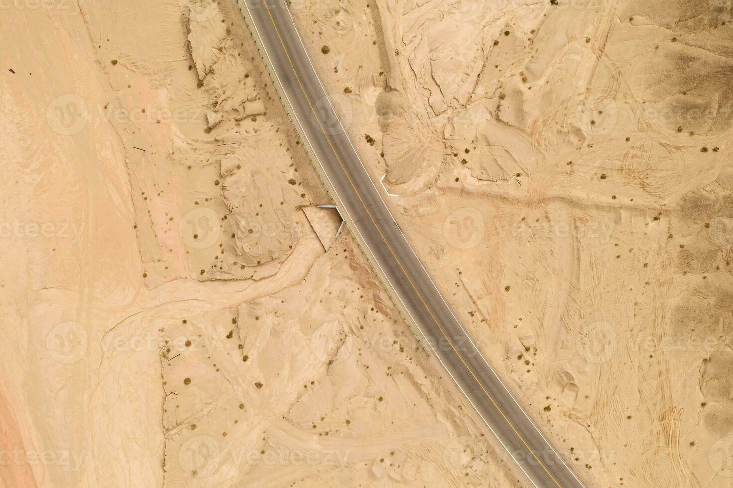 Dryness land with erosion terrain with highway crossing. photo