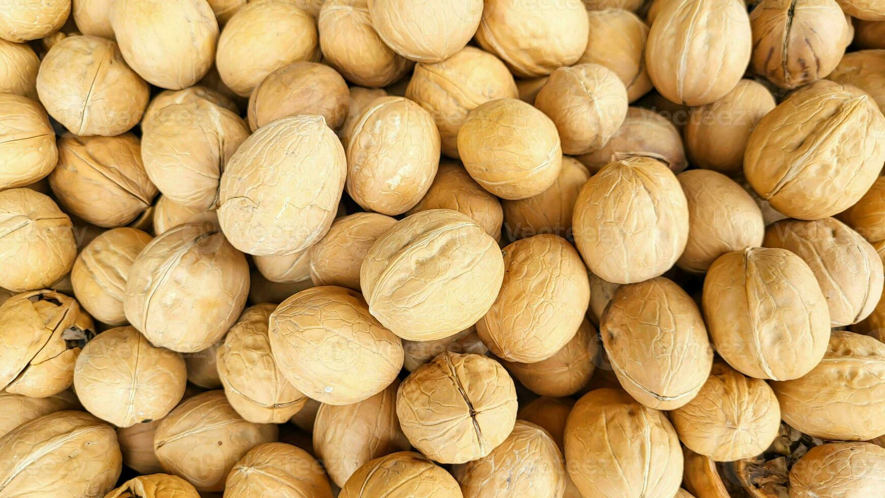 Background of ripe whole walnuts. Nuts on the market counter. photo