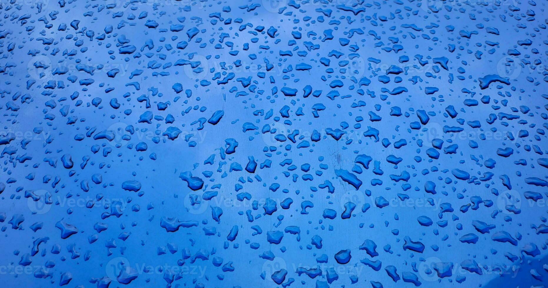 Water drops on the hood of the car after the rain photo