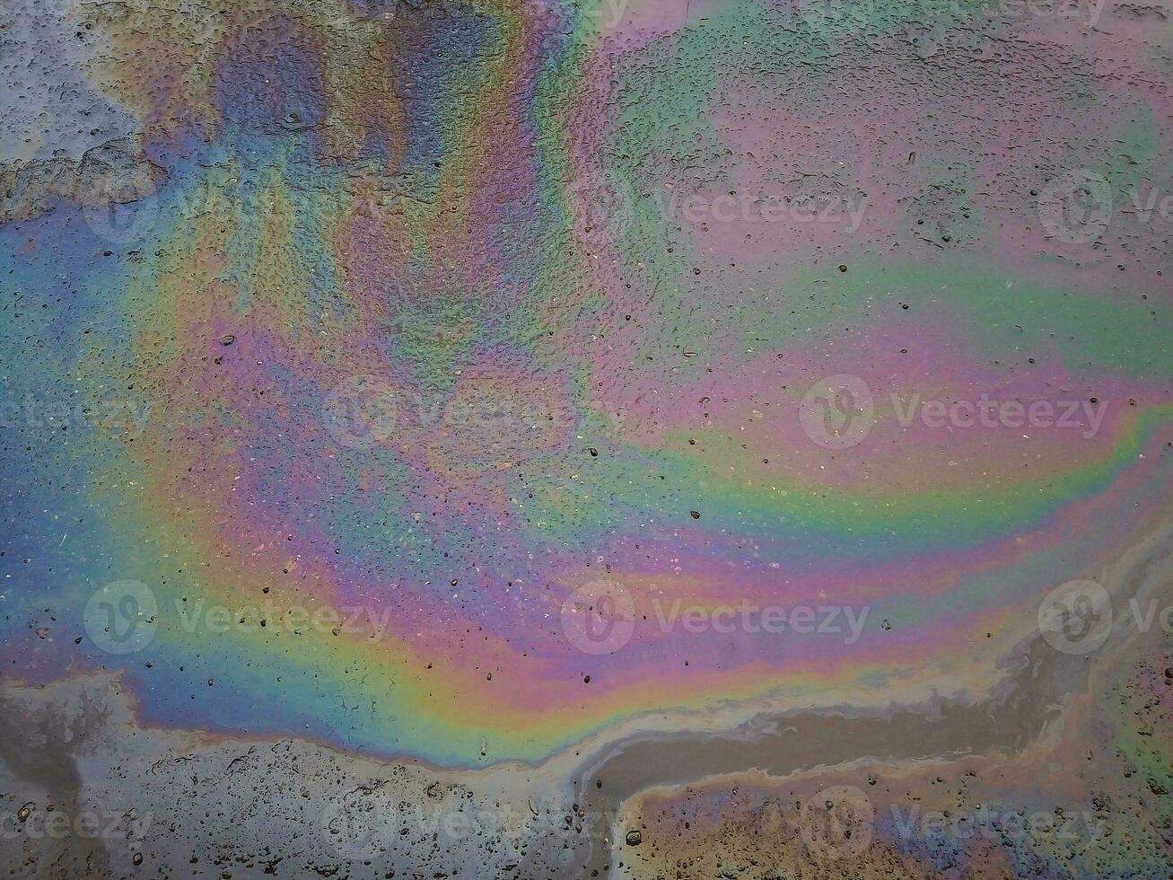 The color diluted with gasoline in a puddle. Environmental pollution photo