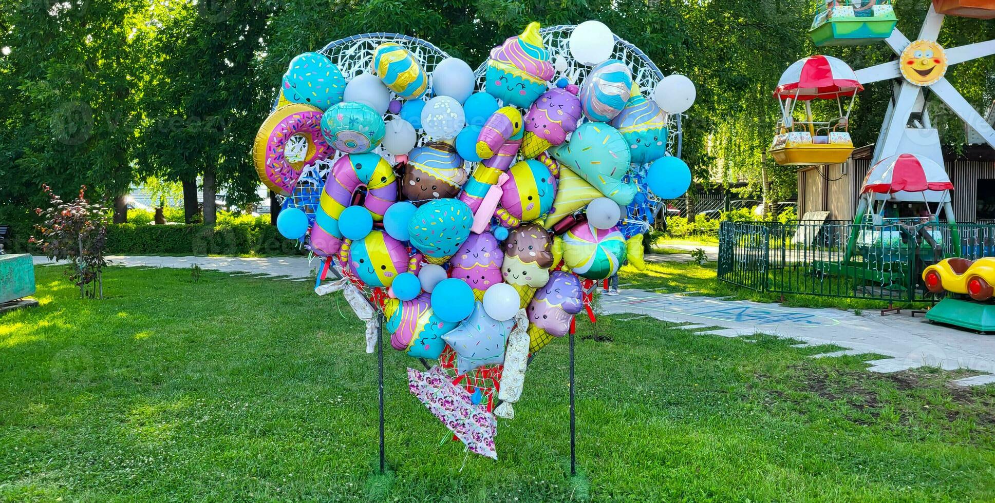 In the park there is a heart made of colorful balloons. photo