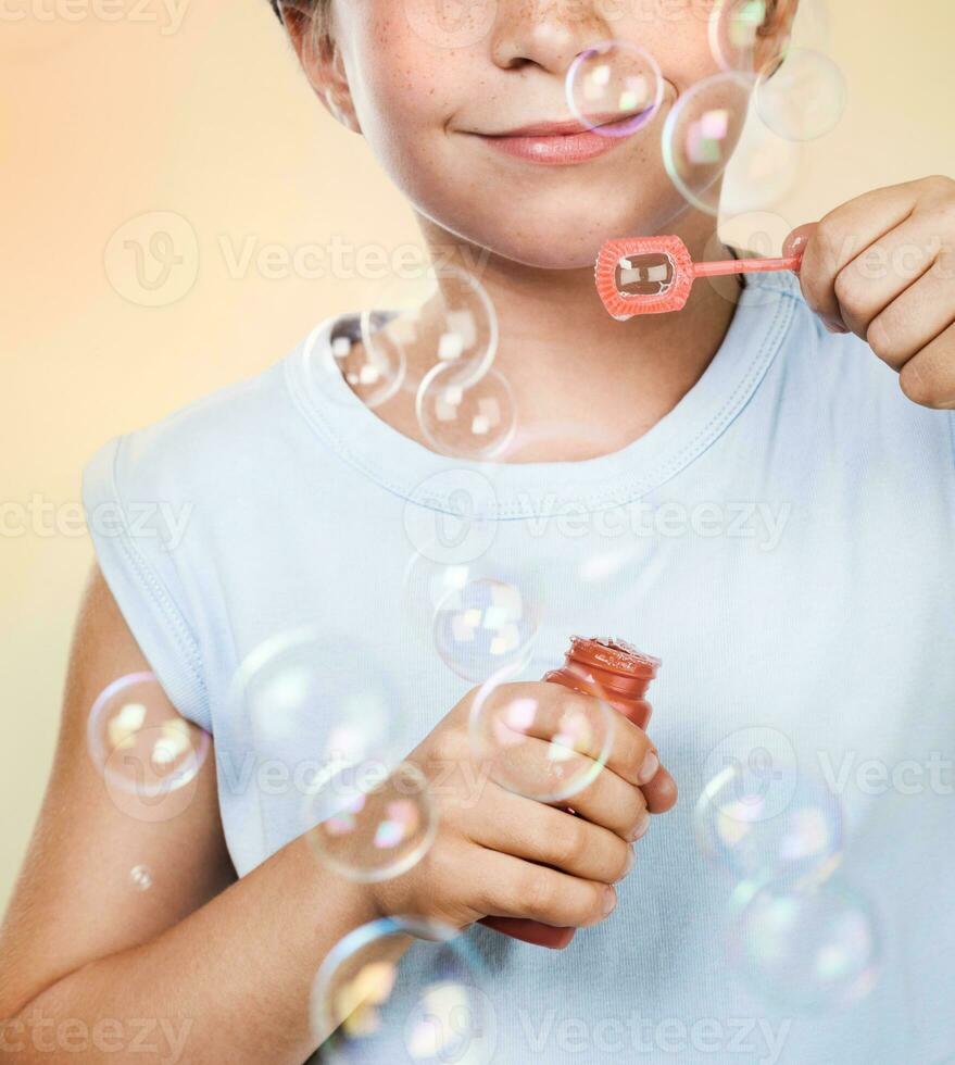 Happy boy blowing bubbles photo